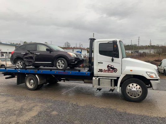 JB Autoworks flatbed towing a car near Bristol